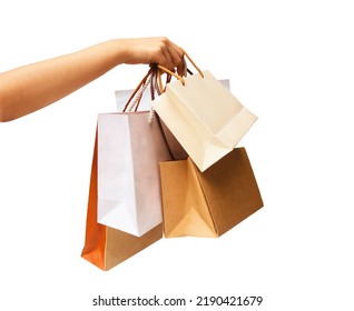hand holding several paper shopping bags isolated on white background - Shutterstock ID 2190421679