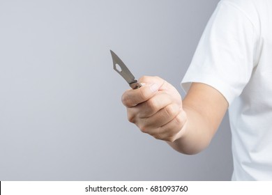 Hand Holding Sharp Pocket Fold Metal Knife On White Background