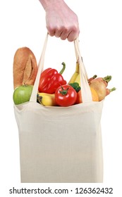 Hand Holding A Shopping Bag Filled With Groceries Such As Fruits And Vegetables, Isolated On White