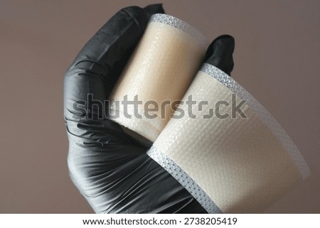 hand holding a silicone patch designed for scars and wounds 