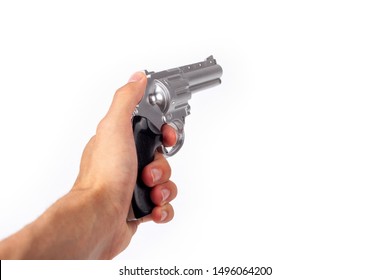 Hand Holding A Silver Gun Pulling The Trigger, Revolver In Hand Pointed Away. Wild West Handgun Silver Bullet Pistol, Dangerous Shooter Concept. Man Pulling The Trigger Closeup Isolated On White