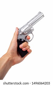 Hand Holding Up A Silver Revolver Pulling The Trigger, Gun In Hand Facing Up Symbol. Wild West Handgun, Silver Bullet Pistol, Dangerous Weapon Concept. Man Firing A Gun Closeup Isolated On White