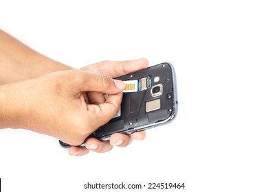 Hand Holding Sim Card And Put Into Smartphone Isolated On White Background