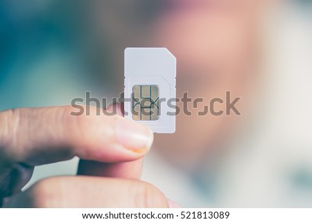 Hand holding sim card, select focus, color effect