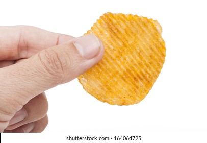 Hand Holding Single Spiced Potato Chip Isolated On White Background