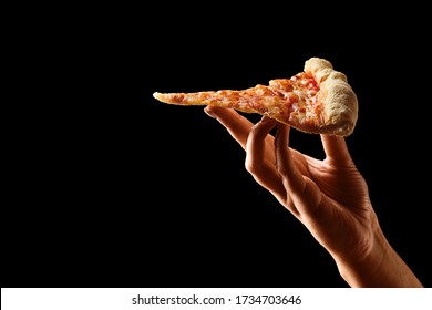 Hand holding slice of cheese pizza cut in slices