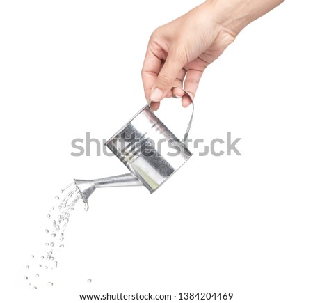 hand holding a small metal watering can with spout isolated on white background