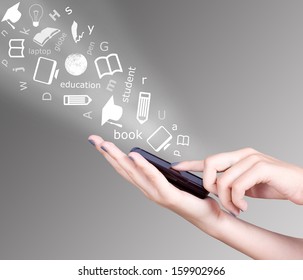 Hand Holding Smart Mobile Phone And Education Symbols Flying Away, Education Concept