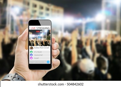 hand holding smart phone live streaming on blurred public concert as background,all graphic in screen are made up - Shutterstock ID 504842602