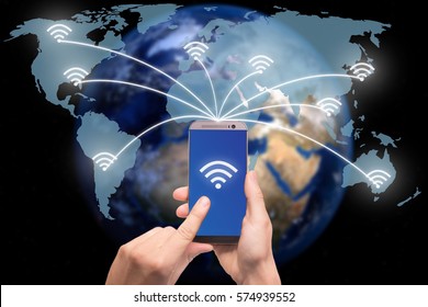 Hand holding smart phone on world map network and wireless communication network, abstract image visual, internet of things.Elements of this image furnished by NASA