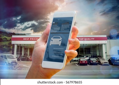 Hand Holding Smartphone Against Car Workshop Building