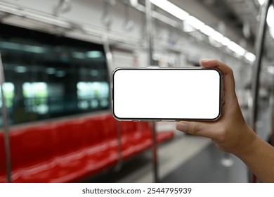 Hand holding smartphone with blank screen on public transportation - Powered by Shutterstock