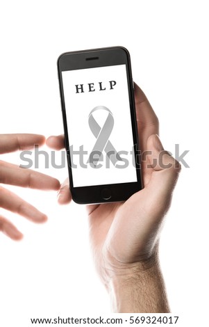 Hand holding smartphone, blank screen with gray ribbon isolated on white background. World Cancer Day graphic. Brain cancer, lung cancer concept