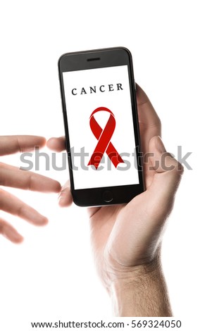 Hand holding smartphone, blank screen with red ribbon isolated on white background. World Cancer Day graphic. AIDS HIV SIDA concept