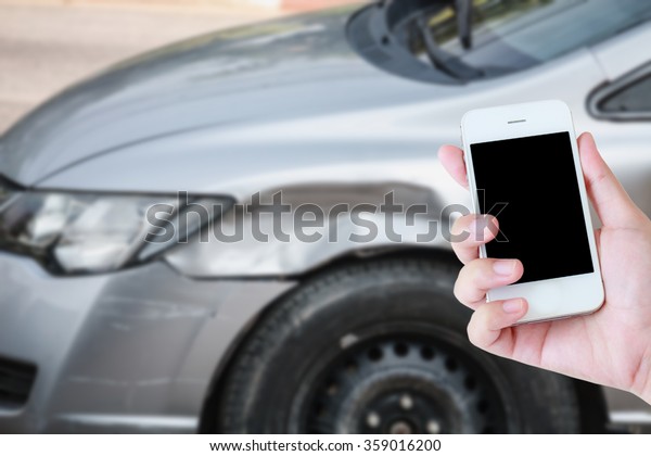 hand holding smartphone with Car crash\
accident background