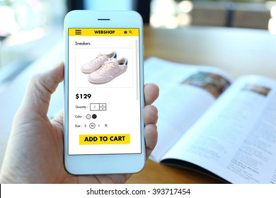 Hand Holding Smartphone With Choose Shoes On Ecommerce Website