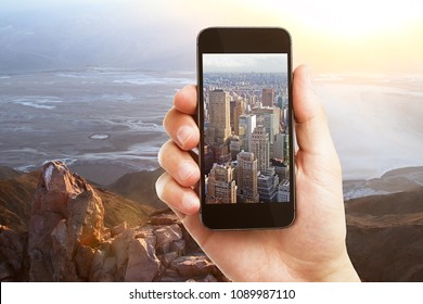 Hand Holding Smartphone With City Image On Creative Landscape Background. Photography And Dream Concept