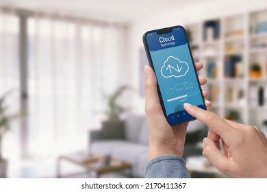 Hand holding a smartphone and cloud-based application, the user is downloading data on the device, POV shot