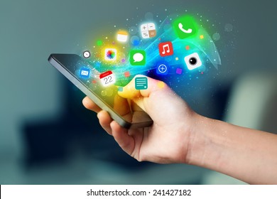 Hand holding smartphone with colorful app icons concept - Shutterstock ID 241427182