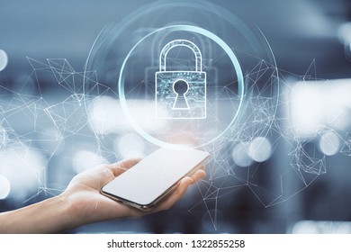 Hand holding smartphone with creative polygonal padlock interface on blurry background. Internet and safety concept. Double exposure 