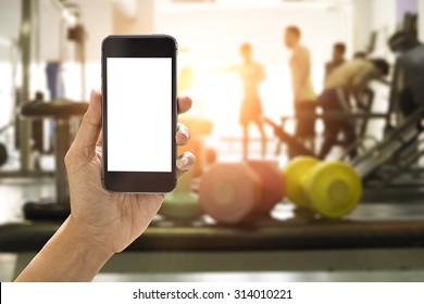 Hand Holding Smartphone Device At Gym Background