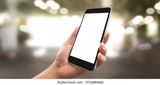 Hand holding smartphone device and touching screen