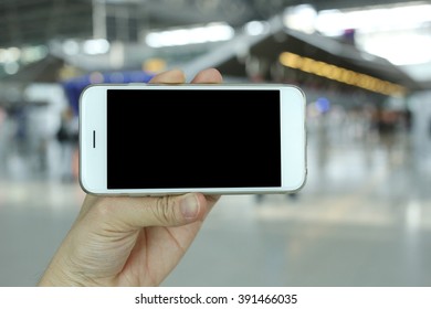 Hand Holding Smartphone Landscape View With Airport Background