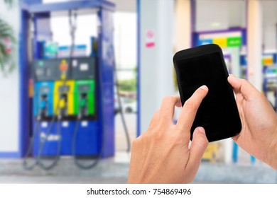 Hand Holding Smartphone With Mobile Wallet To Pay Online At Gas Station.