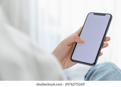 Hand holding smartphone mockup of blank screen for graphic display montage. - Powered by Shutterstock