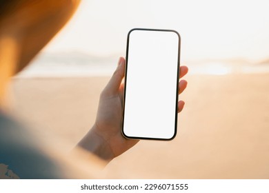Hand holding smartphone on the beach, mobile mockup of blank screen, Take your screen to put on advertising. Summer vacation concept. - Powered by Shutterstock