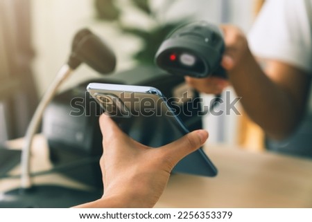 Hand holding smartphone with scan barcode for payment, shopping online, Digital wallet concept.