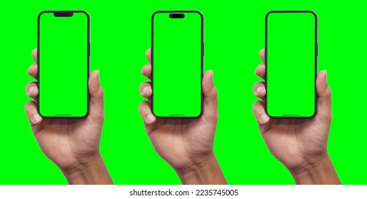 Hand holding smartphone set with green screen for VDO editor and modern frameless design in two rotated perspective positions - isolated on black background - Clipping Path - Powered by Shutterstock