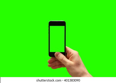 Hand Holding Smartphone And Taking Photo On Greenscreen Background. (Put Your Own Photo Behind And Inside The Phone)