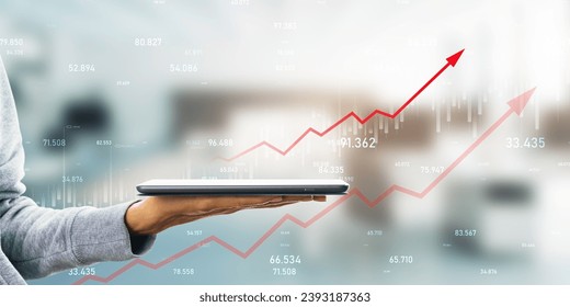Hand holding smartphone with upward trending financial graphs