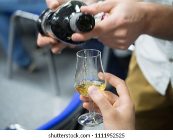 Hand Holding A Snifter Glass Filled With Whisky, Whisky Tasting Event