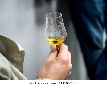 Hand Holding A Snifter Glass Filled With Whisky, Whisky Tasting Event