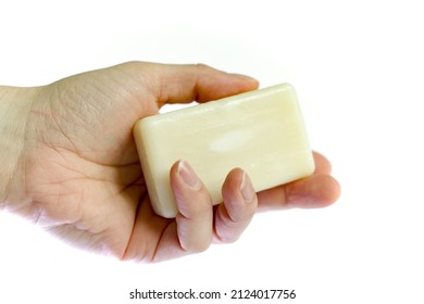 Hand Holding Soap Bar On White Background