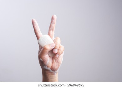 Hand Holding Soap Bar On White Background