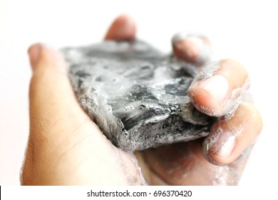 Hand Holding Soap Charcoal Wet And Bubble White Background