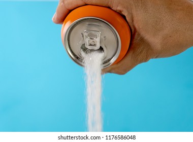 Hand Holding Soda Can Pouring Lots Of Sugar In Metaphor Of Sugar Content Of A Refresh Drink In Healthy Nutrition, Diet, Sweet And Carbonated Drinks Addiction And Unhealthy Food Concept.