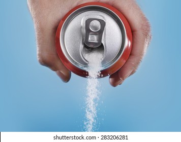 hand holding soda can pouring a crazy amount of sugar in metaphor of sugar content of a refresh drink isolated on blue background in healthy nutrition, diet and sweet addiction concept - Shutterstock ID 283206281