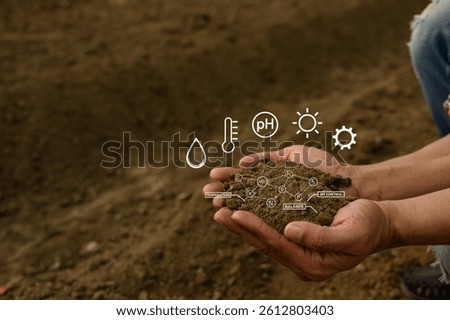 Hand holding soil with virtual interface displaying crucial data on nutrients, temperature, pH and moisture