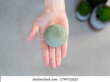 Hand Holding Solid Shampoo Bar