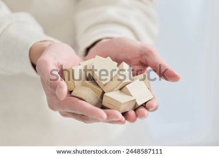 Hand holding a solid wooden block