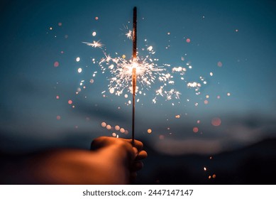 A hand holding a sparkler
 - Powered by Shutterstock