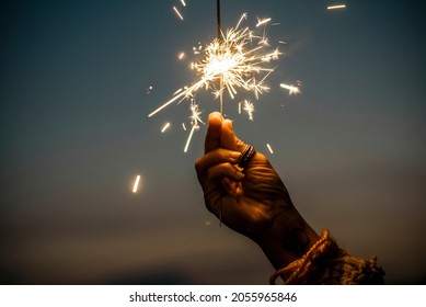 Hand Holding Sparkler Firework Firing With Sunset Sky In Background - Concept Of New Year Eve Celebration People - Hope And Love Image Of Woman Dreams - Warm Tones