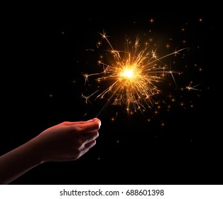 Hand Holding A Sparkler On Black Background