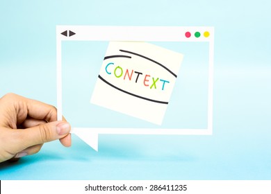 Hand holding speech bubble with the word Context. "Context Marketing" concept.
