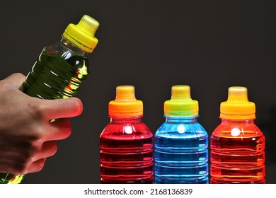 Hand Holding A Sports Drinks, Also Known As Electrolyte Drinks, Are Functional Beverages Whose Stated Purpose Is To Help Athletes Replace Water, Electrolytes, And Energy Before, During Sports Activity