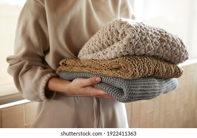 Hand holding a stack of sustainable cloths in tracksuit, homemade and Eco friendly fabric